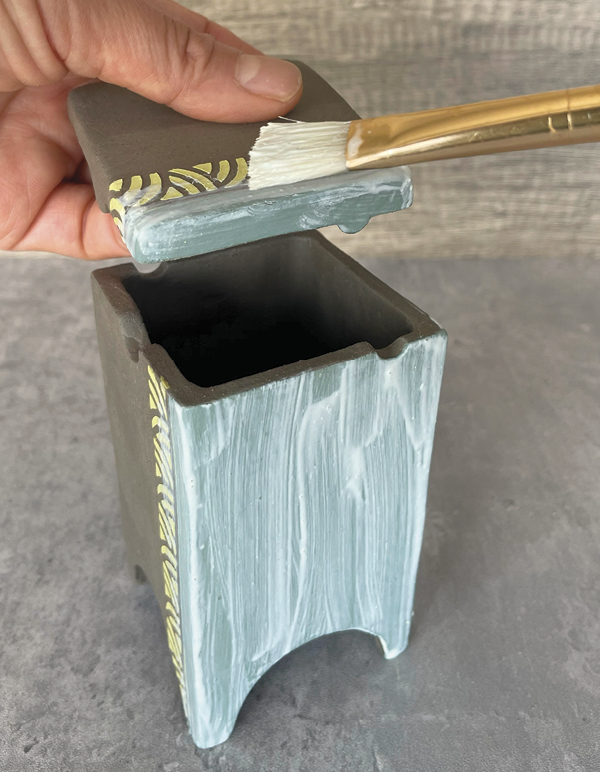 9 Brush wax on the surface that will later be used for carving and inlaying.