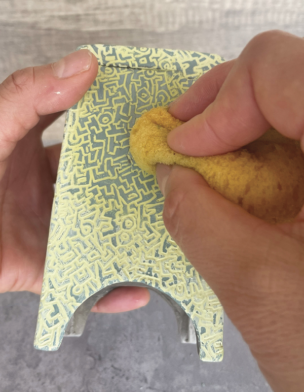 12 Wipe the dried excess underglaze with a wrung-out, damp sponge.