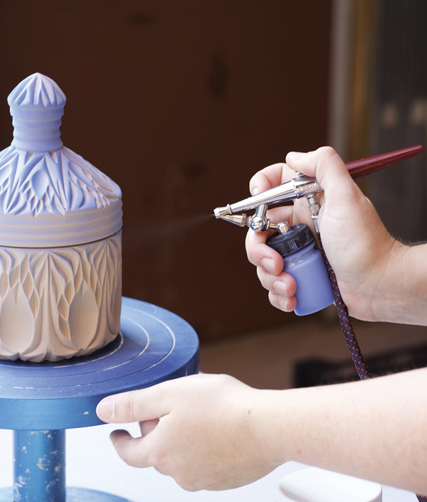 17 Spray at an angle parallel to the piece, so underglaze only coats one facet of the carving as your piece turns.
