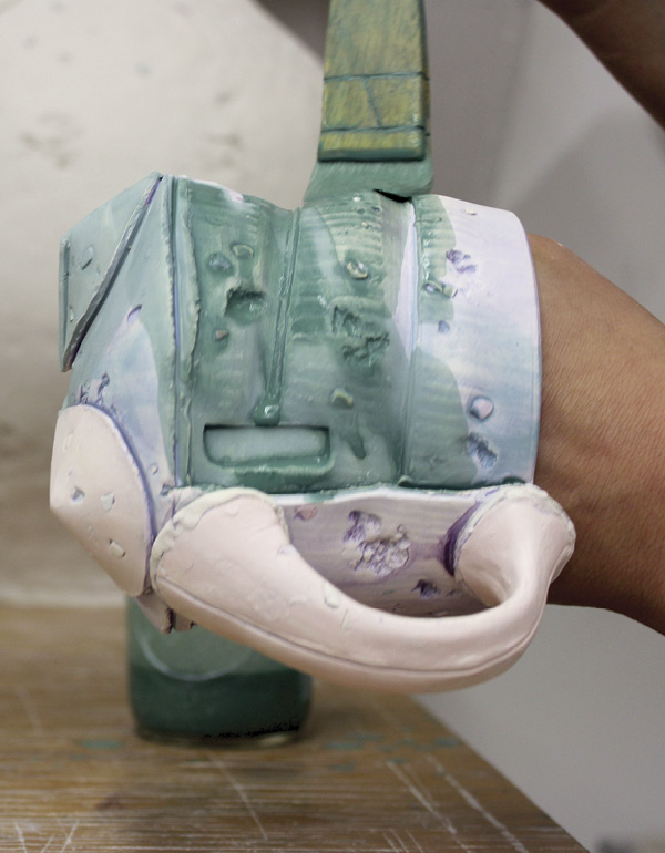 14 Applying a Mason-stain wash to the pots after a cone-06 bisque firing.
