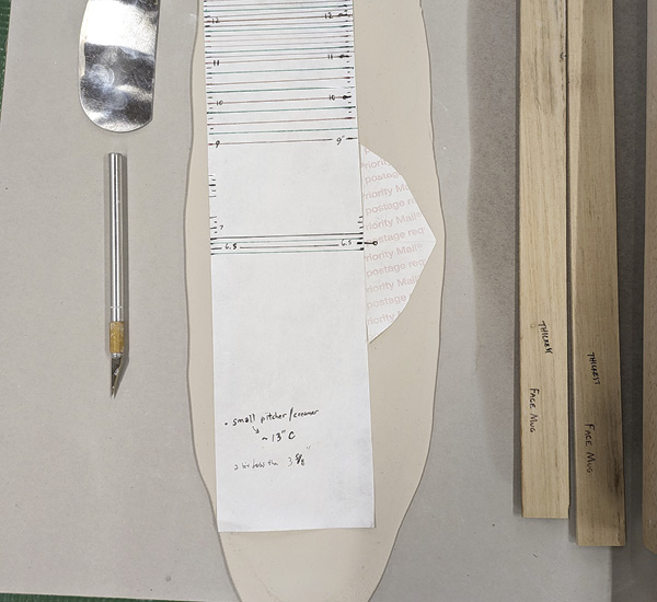 1 Lay body template on the clay and position the spout template in the center.