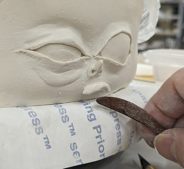 8 Bring piece to edge of wareboard so you can sculpt a coil into a lip.
