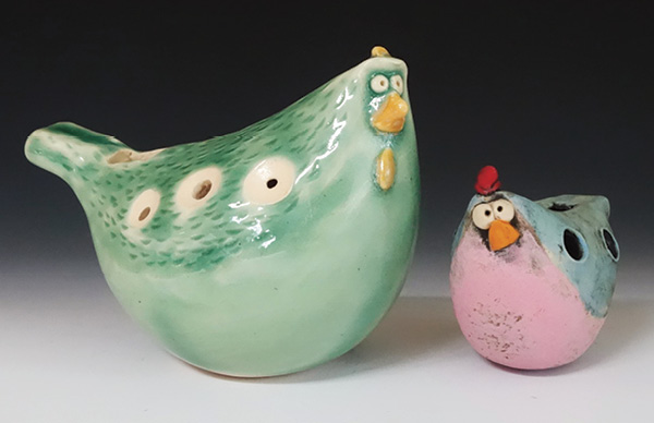 Ocarinas, wheel thrown and altered, underglazes, glazes, fired in oxidation to cone 6. A 7-hole linearly-fingered ocarina (left, 3 in. (7.6 cm) in height, 2015) and a 4-hole cross-fingered ocarina (right, 2 in. (5.1 cm) in height, 2023.