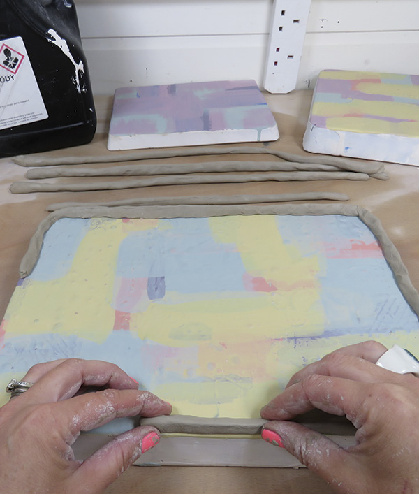 10 Make a wall using coils around the plaster bat perimeter. Make sure the join is secured to the plaster.