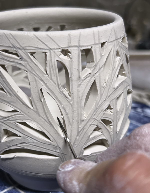 7 Use the side of needle tool to compress and smooth corners where cuts meet.