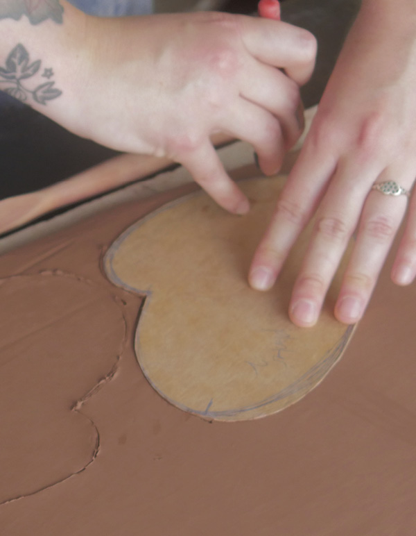 2 Roll out an even slab and cut two base pieces using the template.