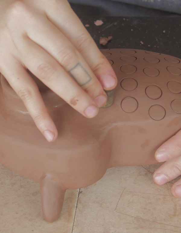 14 Stamp a pattern. Metal cookie cutters work best to leave a crisp line in clay.