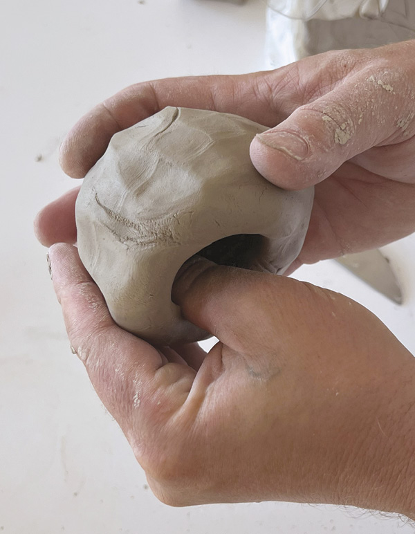 3 Begin with an apple-sized ball of clay and pinch to form a hemispheric base.