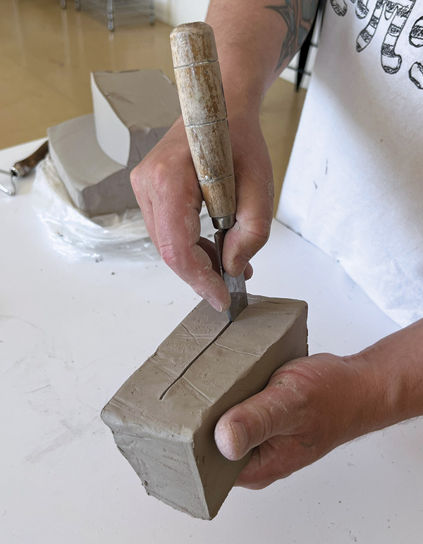 5 Use knife to make an opening in a block of clay. This will become a hollow base.