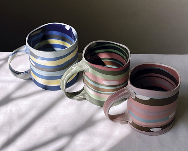 Renee Tsai's Striped mugs formed with nerikomi slabs, 3¾ in. (9.5 cm) in height.