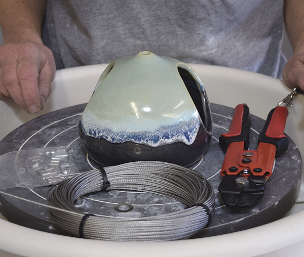 7 Get ready to make a cable to hang the dome feeder with. Assemble these materials: 1⁄16-in. (0.2-cm) stainless-steel cable, crimps, crimping tool, and a metal washer.
