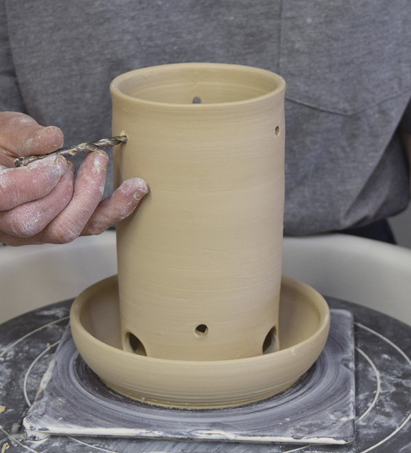 12 Drill or poke three ¼-in. (0.6-cm) holes in the top of the feeder above the ports for hanging the feeder.