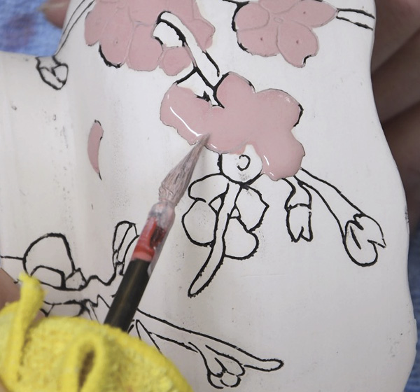 8 Flood the foreground images with thinned underglaze, then let it dry.