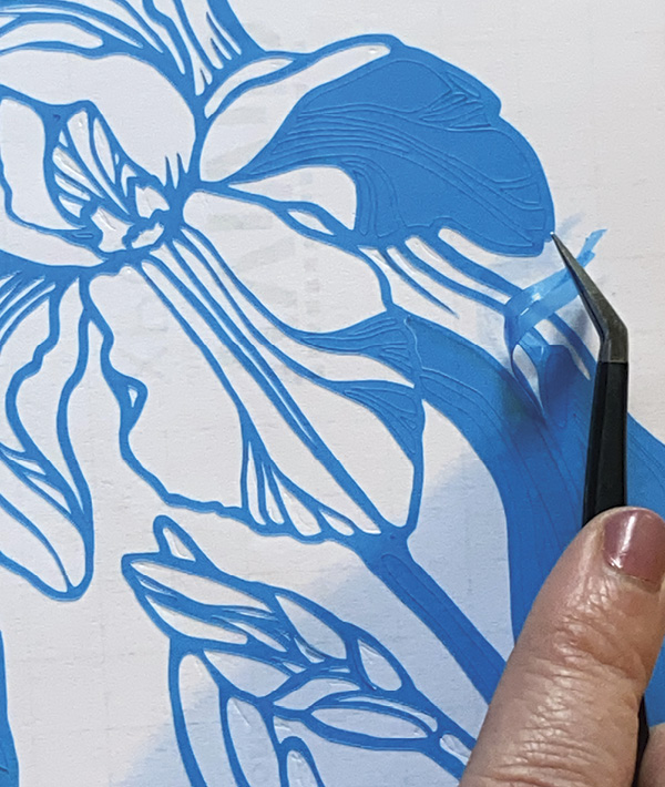 6 Use tweezers to remove the excess vinyl from the negative space and background of your image.