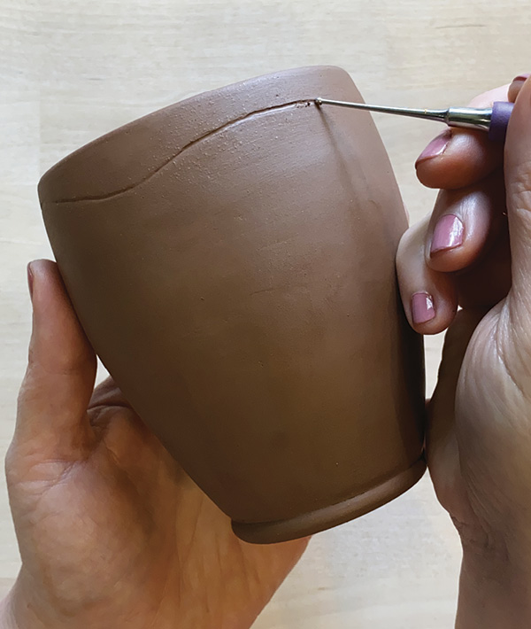 7 Create a simple thrown or handbuilt form. Use a ball stylus to denote lines for the lip and foot of your vessel.