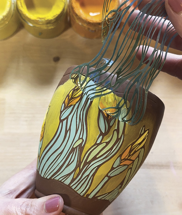 5 Repeat the process of placing, adhering, coloring, and removing a stencil on the back of your vessel.