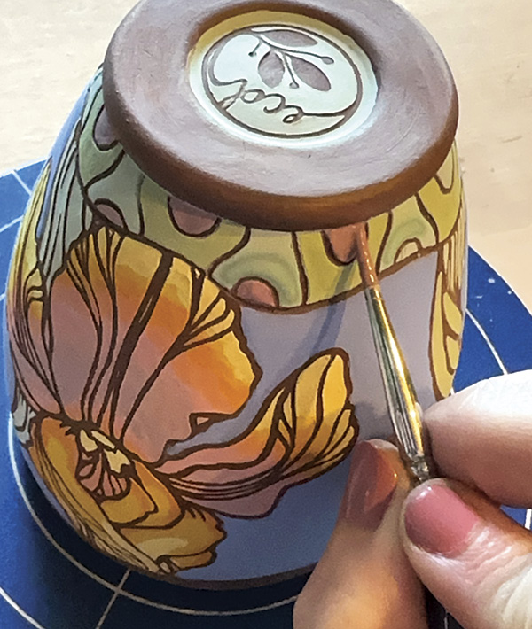15 Once you have made it around the entire vessel, fill in your newly carved pattern with two coats of underglaze.