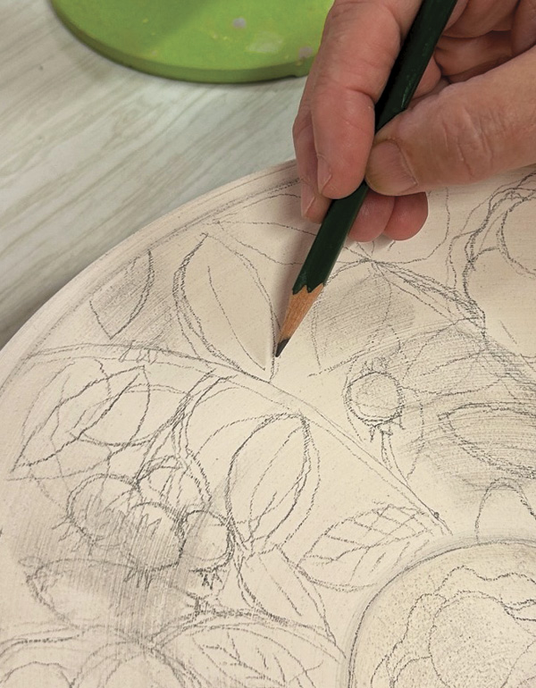 1 Draw a pattern or design directly onto bisque-fired pottery.