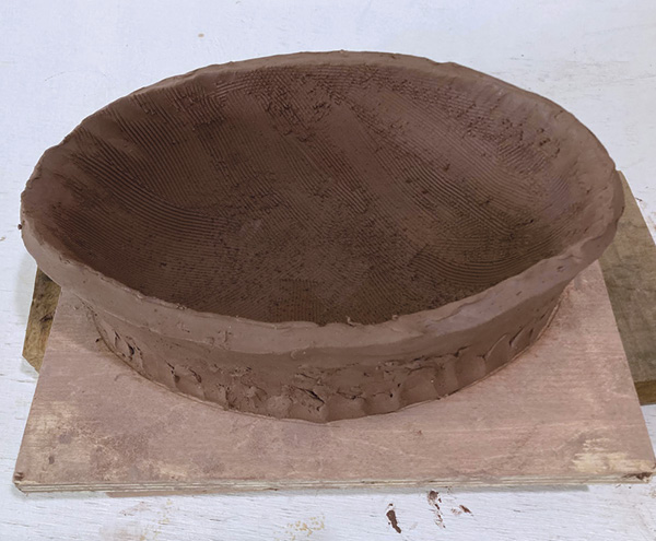6 Use a serrated rib to smooth the interior and establish the inside profile.