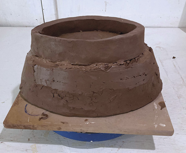 8 Score, slip, and add the foot, insetting it onto the curved dome of the floor to continue to angle of the walls.
