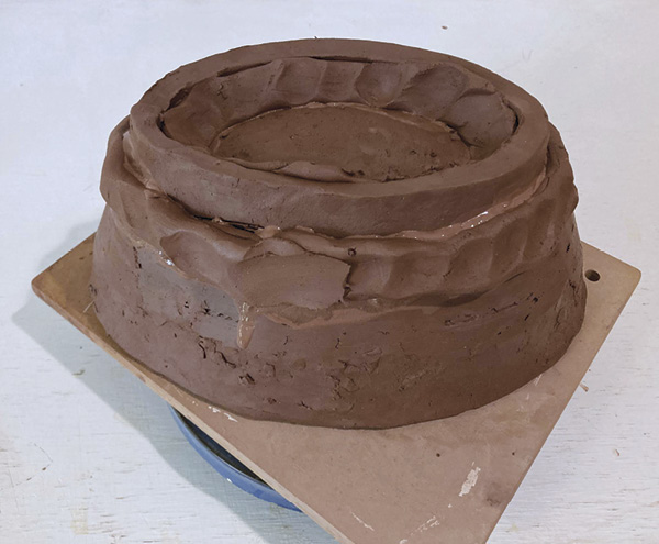 9 Once foot is leather hard, add soft coils to both the interior and exterior joins, working them into the pot.  Allow it to set up.
