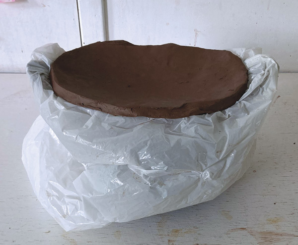 13  Refine the interior and exterior, then wrap the server in plastic. Slump a slab for a lid, using the pot as the slump mold.