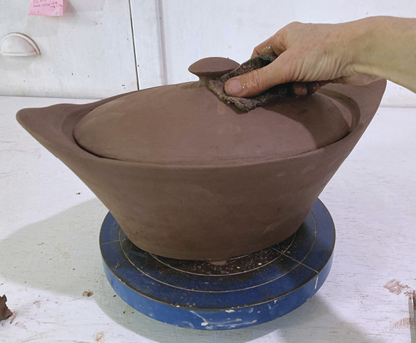 16 Once leather hard, use a Surform, knife, scouring pad, and sponge to define the knob.