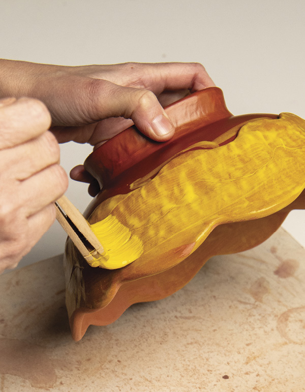 8 Brush 2–3 coats of bright underglaze to the pinched coil walls.