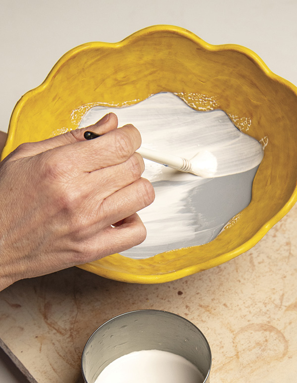 10 Apply white underglaze using varied brush strokes.