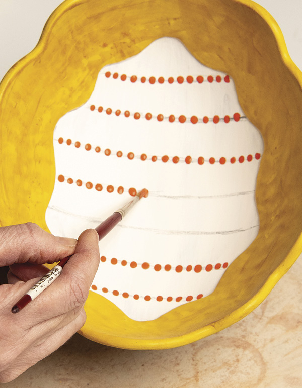 11 Brush on rows of polka dots in a bright-colored underglaze.
