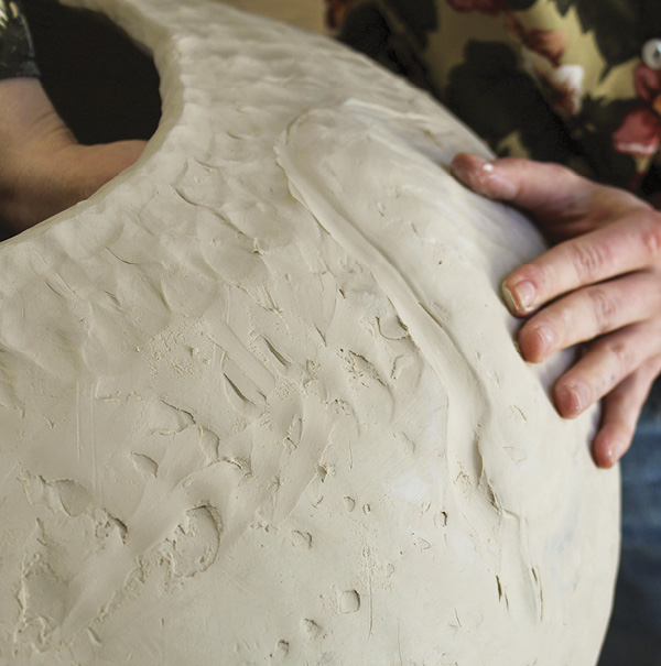3 Following the outline, gently push out clay into that image.