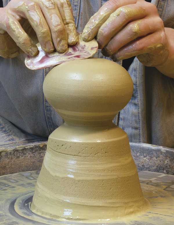 2 Pull the form into an enclosed orb, then shape it into an oblong sphere.