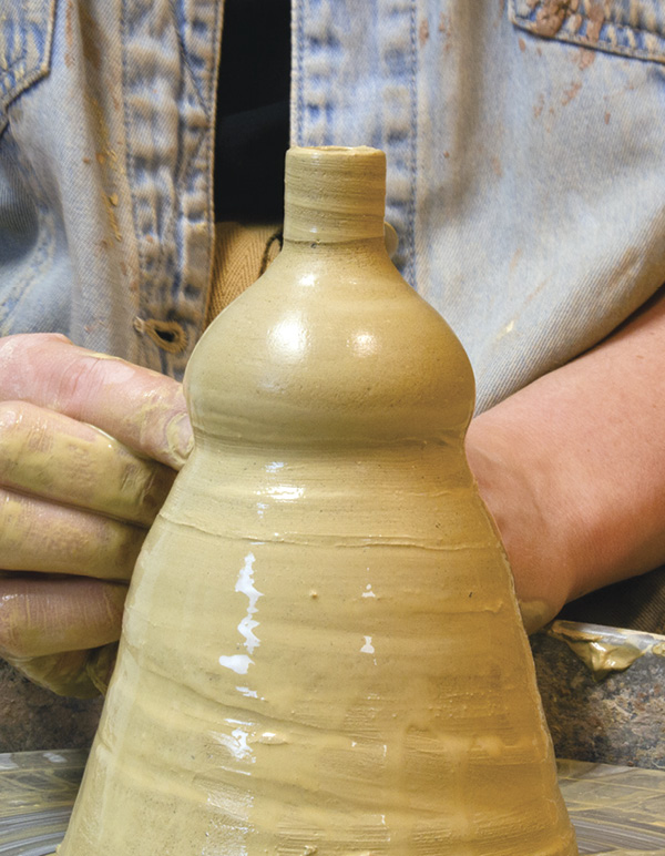 5 Pull the clay into a form resembling an upside-down funnel.
