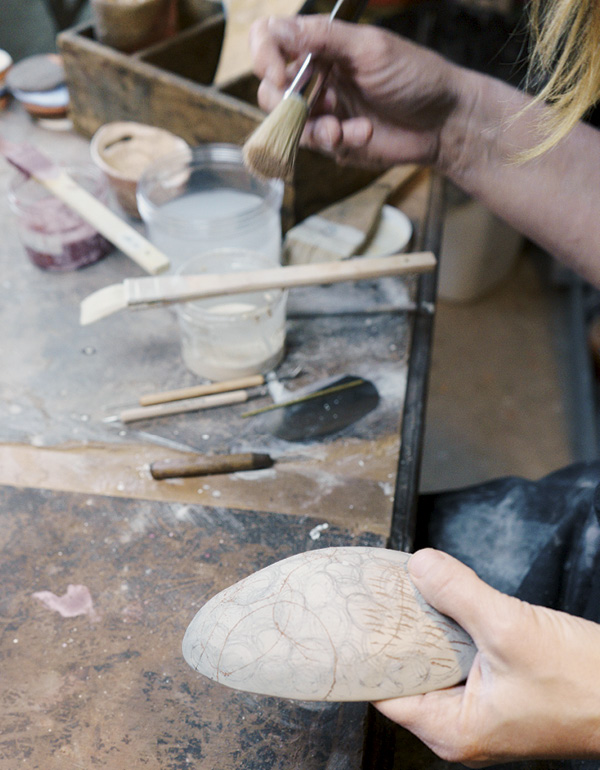 5 Use a duster brush to remove tiny clay burrs from the surface.