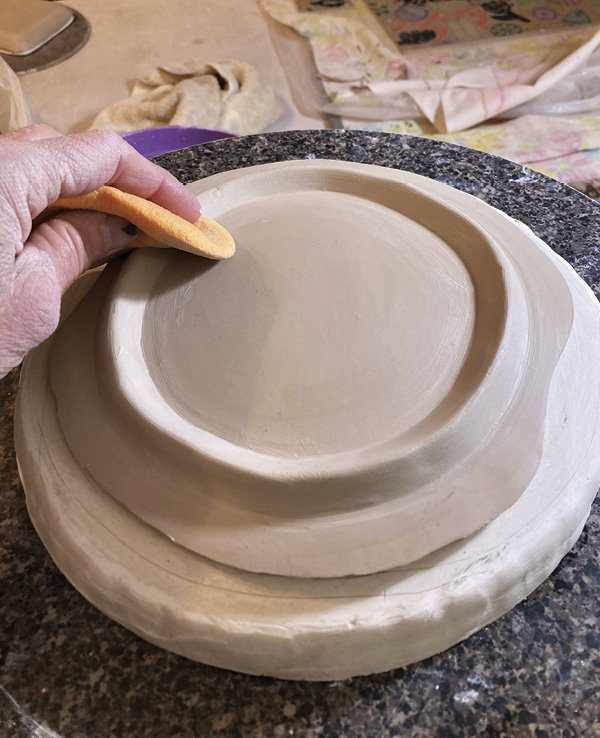 17 Place the slab face down on a small mold with a slight curve. Attach a foot.