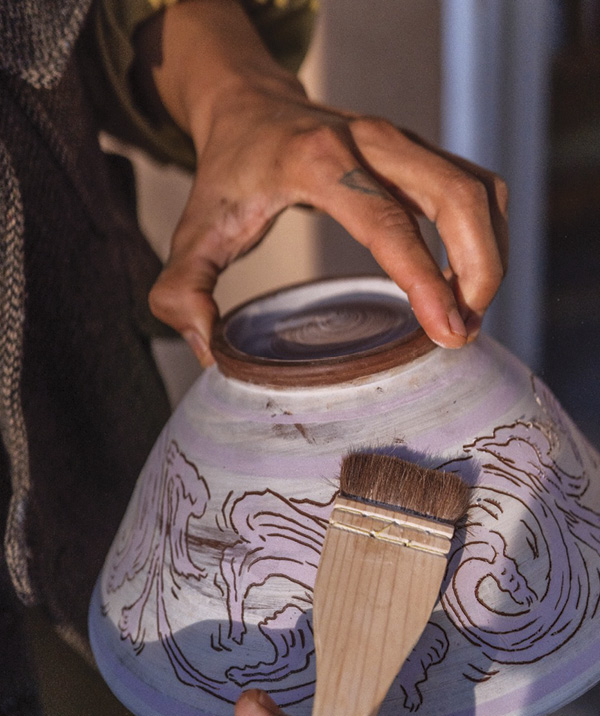 5 Once the piece slightly dries, gently brush off any of the clay debris from the carving. Allow the piece to fully dry.