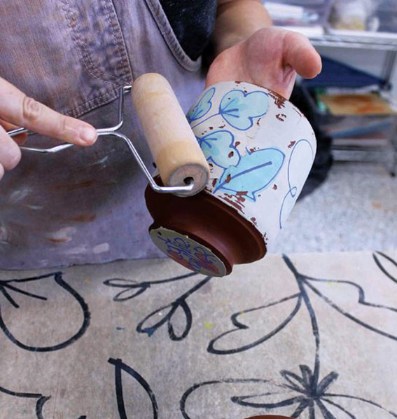 7 When the slip has dried to a satin-sheen, it’s ready to be applied to the clay form using a rubber rib as a squeegee.