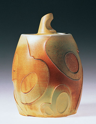 The interesting relief textures on this jar by Ryan McKerley, were made using the technique described here.