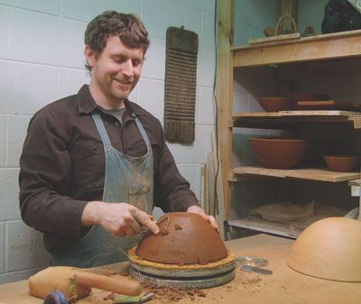 Joe Pintz refines the outer surface of a bowl in his studio at Bowling Green State University in Bowling Green, Ohio.
