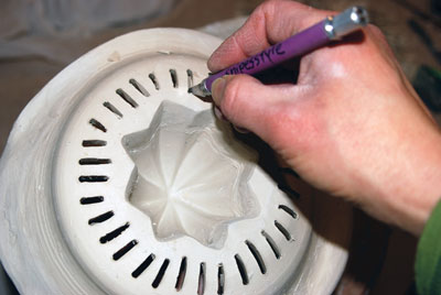 12. Cutting the seed-catching slots using a utility knife.
