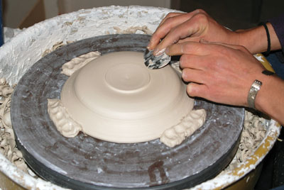 3. Compressing the clay after trimming the juicer bottom.