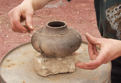 Fig 5. Place horse hairs (or other animal or human hair) on the pot immediately after removing it from the fire.