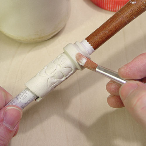 Fig.13 Make the neck on a dowel then add a flange with a thin, clay strip.