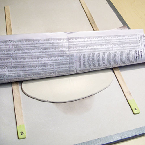Fig.B Roll the clay between the spacers to thin it. Rotate and flip the clay to prevent warping.