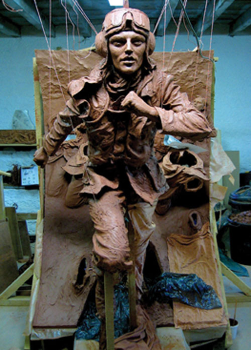 The Battle of Britain London Monument in progress, with a suspended wooden armature that was built as the figures were constructed.