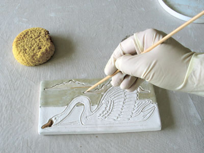 1. Remove excess glaze with a pointed tool from all areas that will receive grout.