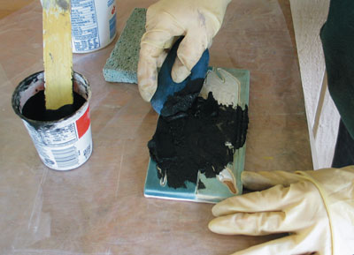 3. Apply grout to the tile surface with a flexible tool. Wear protective gloves.