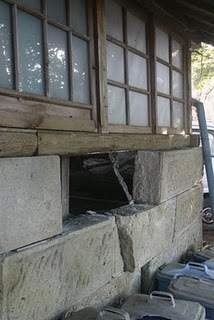 The damaged back wall of Euan's Craig's house and studio.