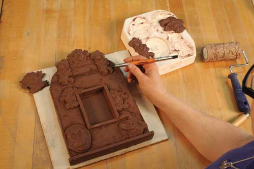 Fig. 1 Using a sprigs from a Day of the Dead mold from Amaco, Tracy adds details and texture.