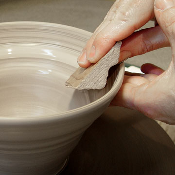 Press the molding into the rim while supporting the outside.